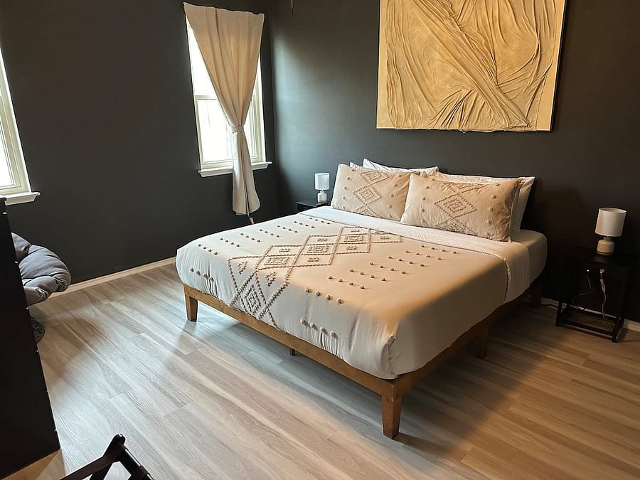 Master bedroom with a king bed and wood frame