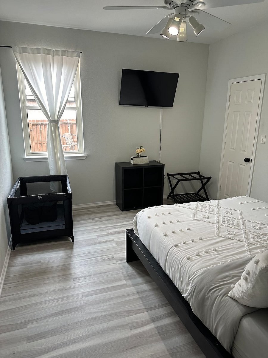 Second bedroom with a queen bed, TV, and a pack n play